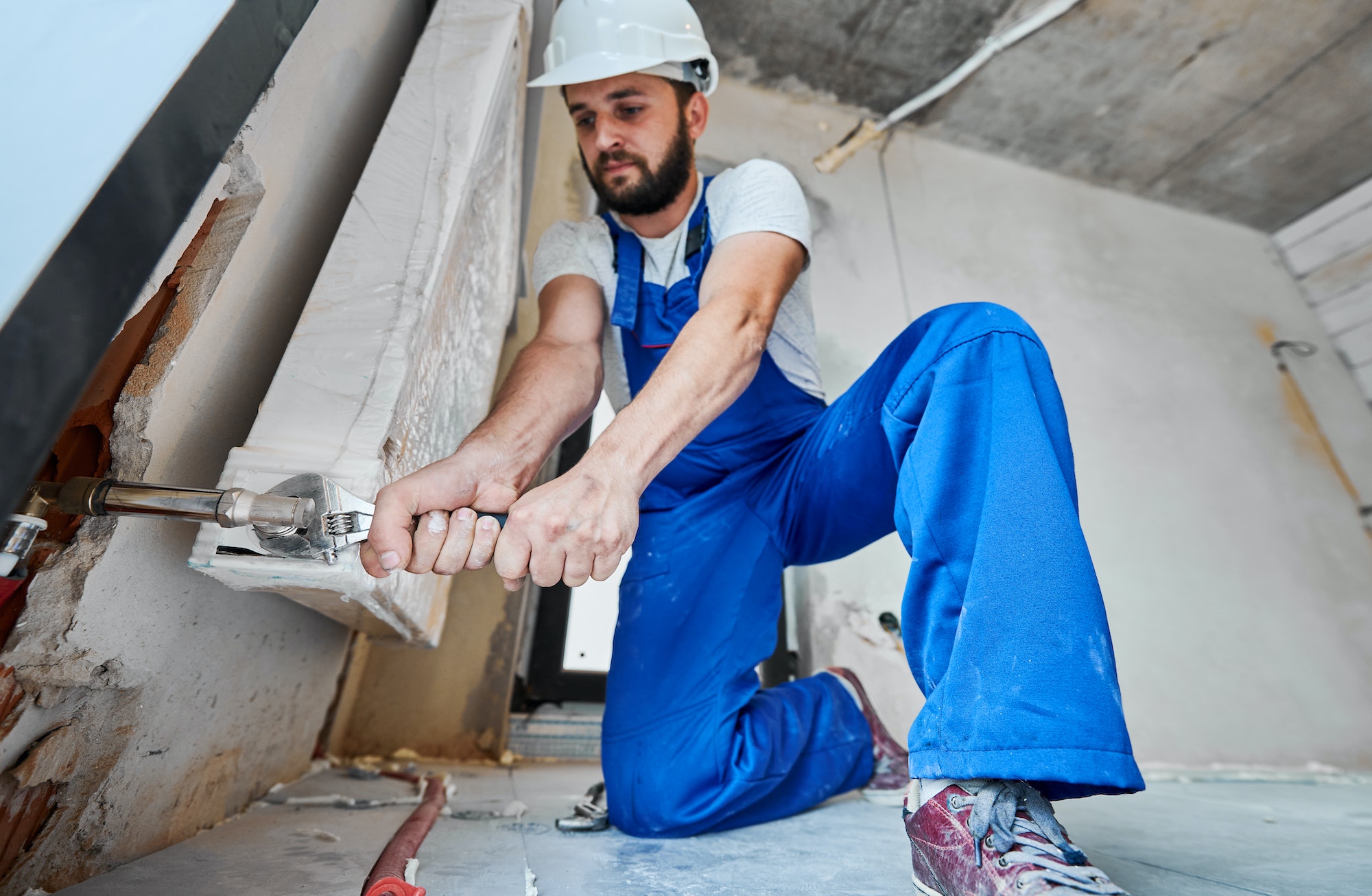 plumber-screwing-plumbing-fittings-with-a-wrench.jpg plumber-screwing-plumbing-fittings-with-a-wrench.jpg